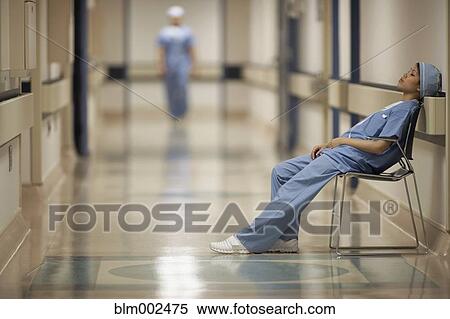 Stock Photography - Asian female medical professional sitting in chair. Fotosearch