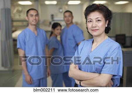 Stock Image - Asian female medical professional with arms crossed. Fotosearch