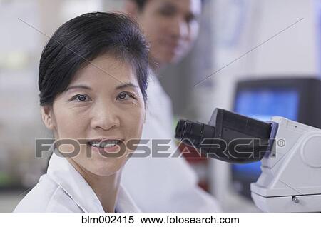 Asian female scientist next to microscope View Large Photo Image Stock Photography - Asian female scientist next to microscope. Fotosearch