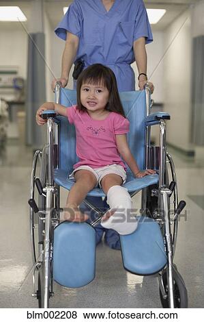 Stock Photo - Asian girl with cast in wheelchair. Fotosearch