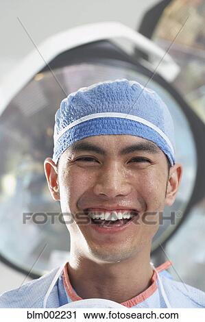 Asian male doctor with sweat on face View Large Photo Image Stock Image - Asian male doctor with sweat on face. Fotosearch