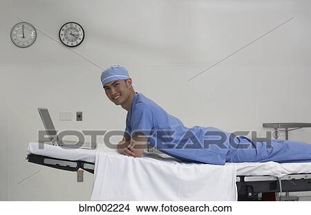 Asian male medical professional on hospital bed View Large Photo Image Picture - Asian male medical professional on hospital bed. Fotosearch