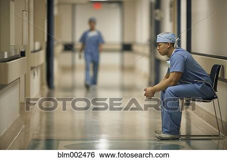 Asian male medical professional sitting in chair View Large Photo Image Stock Photograph - Asian male medical professional sitting in chair. Fotosearch
