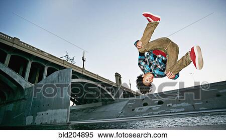 Stock Photography - Asian man break dancing under overpass. Fotosearch