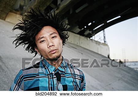 Asian man standing under overpass View Large Photo Image Stock Image - Asian man standing under overpass. Fotosearch