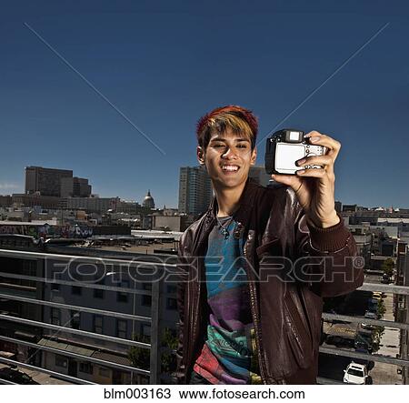 Asian man taking self-portrait with digital camera View Large Photo Image Stock Image - Asian man taking self-portrait with digital camera. Fotosearch