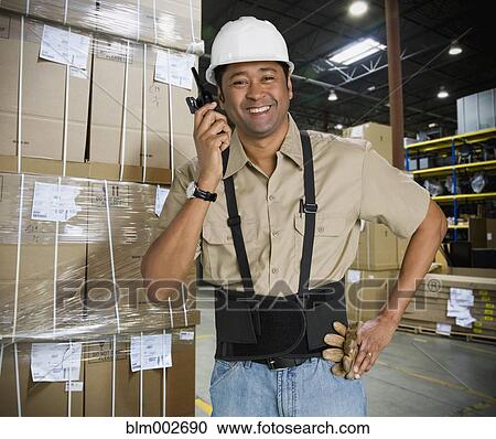 Stock Image - Asian man working in warehouse. Fotosearch