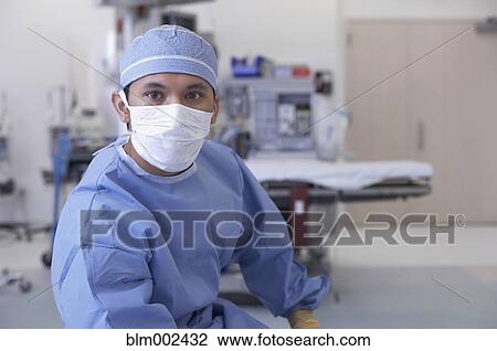 Stock Image - Asian medical professional wearing surgical mask. Fotosearch