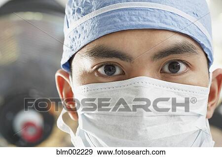 Stock Photo - Asian medical professional wearing surgical mask. Fotosearch