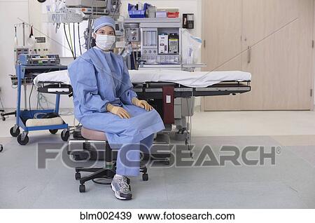 Asian medical professional wearing surgical mask View Large Photo Image Stock Photo - Asian medical professional wearing surgical mask. Fotosearch