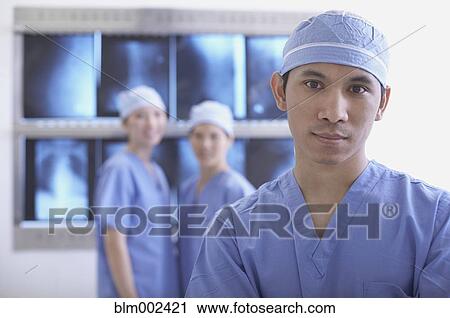 Stock Image - Asian medical professionals in front of x-rays. Fotosearch