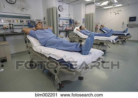 Stock Image - Asian medical professionals in hospital beds. Fotosearch