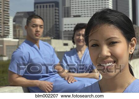 Stock Photo - Asian medical professionals outdoors. Fotosearch