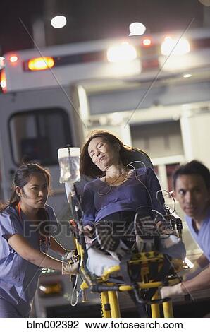 Asian medical professionals pushing patient on gurney View Large Photo Image Stock Image - Asian medical professionals pushing patient on gurney. Fotosearch