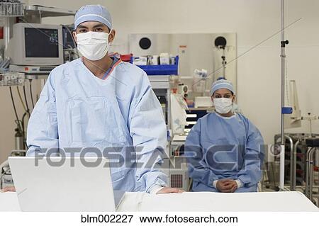 Stock Photo - Asian medical professionals wearing surgical masks. Fotosearch