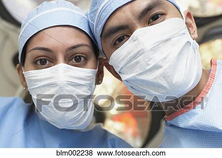 Asian medical professionals wearing surgical masks View Large Photo Image Stock Photo - Asian medical professionals wearing surgical masks. Fotosearch