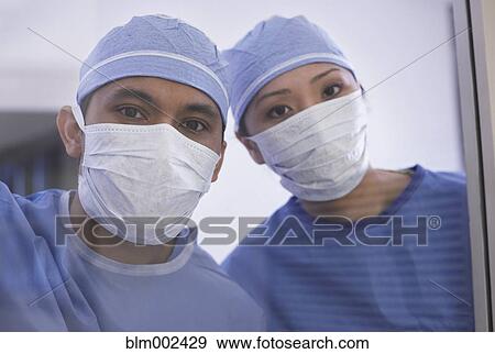 Stock Photo - Asian medical professionals wearing surgical masks. Fotosearch