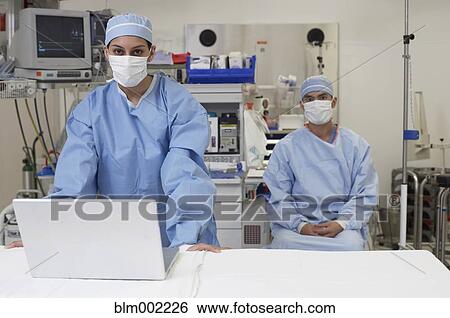 Stock Photograph - Asian medical professionals wearing surgical masks. Fotosearch