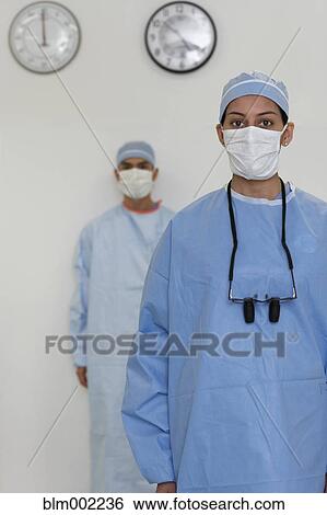 Stock Photograph - Asian medical professionals wearing surgical masks. Fotosearch