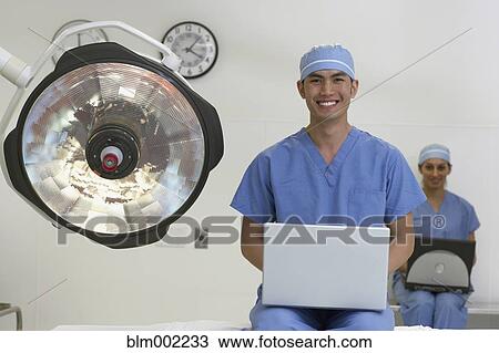 Stock Image - Asian medical professionals with laptops. Fotosearch
