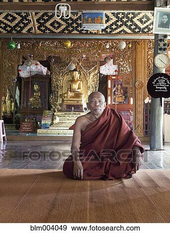 Stock Photo - Asian monk sitting in temple. Fotosearch