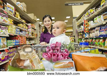 Asian mother shopping in grocery store with daughter View Large Photo Image Stock Image - Asian mother shopping in grocery store with daughter. Fotosearch
