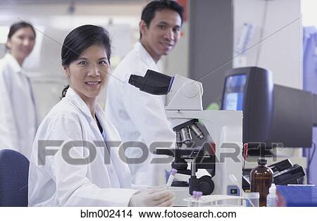 Picture - Asian scientists in laboratory. Fotosearch
