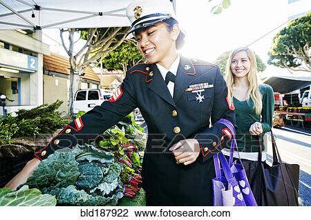 Asian soldier and friend shopping in farmers market View Large Photo Image Stock Image - Asian soldier and friend shopping in farmers market. Fotosearch