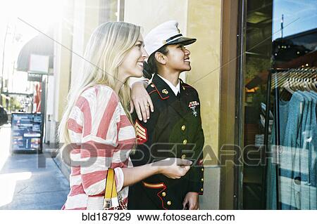 Asian soldier and friend window shopping View Large Photo Image Stock Photo - Asian soldier and friend window shopping. Fotosearch
