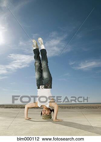 Asian woman doing headstand View Large Photo Image Stock Image - Asian woman doing headstand. Fotosearch