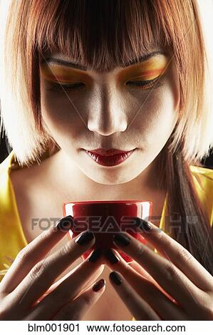 Asian woman holding tea cup View Large Photo Image Stock Image - Asian woman holding tea cup. Fotosearch