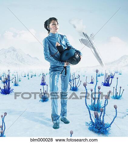 Stock Photo - Asian woman in front of spaceship on alien planet. Fotosearch