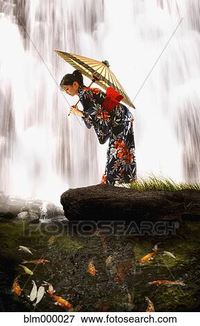 Stock Photo - Asian woman in geisha dress holding parasol. Fotosearch