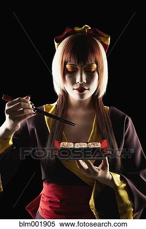 Asian woman in traditional clothing eating sushi View Large Photo Image Stock Photography - Asian woman in traditional clothing eating sushi. Fotosearch