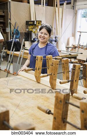 Picture - Asian woman in workshop. Fotosearch