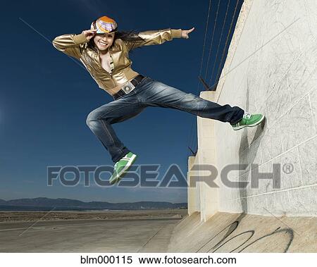 Asian woman jumping off wall View Large Photo Image Stock Photography - Asian woman jumping off wall. Fotosearch