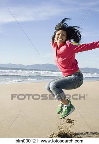 Asian woman jumping on beach View Large Photo Image Stock Image - Asian woman jumping on beach. Fotosearch