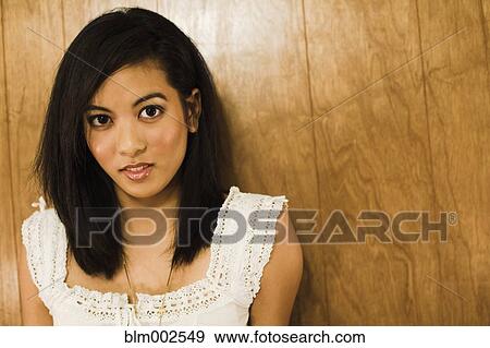 Asian woman leaning against wall View Large Photo Image Stock Photo - Asian woman leaning against wall. Fotosearch