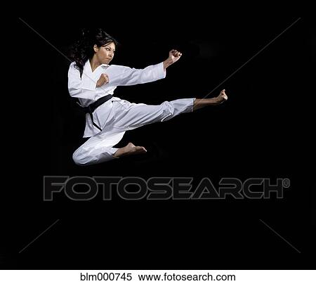 Stock Photography - Asian woman practicing martial arts. Fotosearch