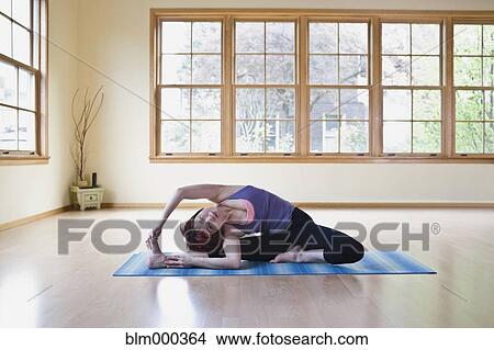Picture - Asian woman practicing yoga. Fotosearch