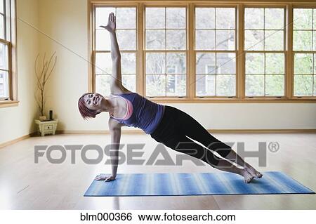 Asian woman practicing yoga View Large Photo Image Stock Photograph - Asian woman practicing yoga. Fotosearch