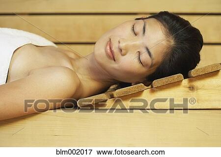 Asian woman relaxing in sauna View Large Photo Image Stock Photo - Asian woman relaxing in sauna. Fotosearch