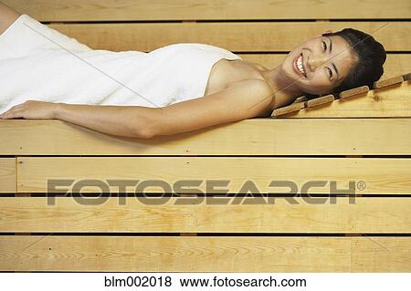 Asian woman relaxing in sauna View Large Photo Image Stock Photo - Asian woman relaxing in sauna. Fotosearch