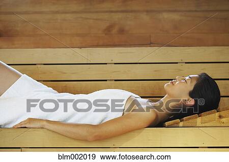 Asian woman relaxing in sauna View Large Photo Image Stock Photo - Asian woman relaxing in sauna. Fotosearch
