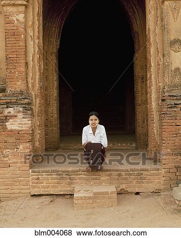 Asian woman smiling at temple entrance View Large Photo Image Stock Photo - Asian woman smiling at temple entrance. Fotosearch