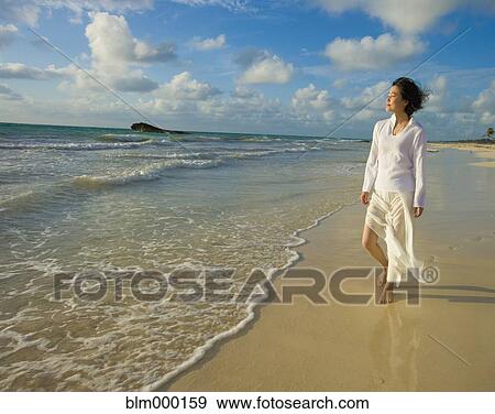 Asian woman walking on beach View Large Photo Image Stock Photo - Asian woman walking on beach. Fotosearch