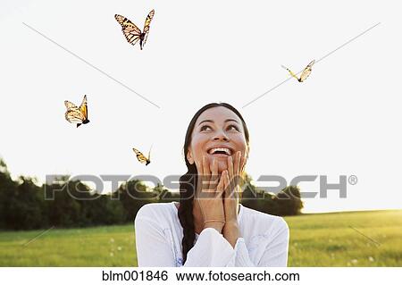 Asian woman watching butterflies in meadow View Large Photo Image Stock Photograph - Asian woman watching butterflies in meadow. Fotosearch