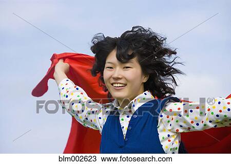 Stock Image - Asian woman with hair blowing. Fotosearch