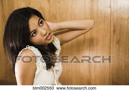 Asian woman with hand in hair View Large Photo Image Stock Image - Asian woman with hand in hair. Fotosearch