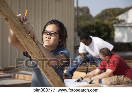 Asian woman working at construction site View Large Photo Image Stock Photo - Asian woman working at construction site. Fotosearch